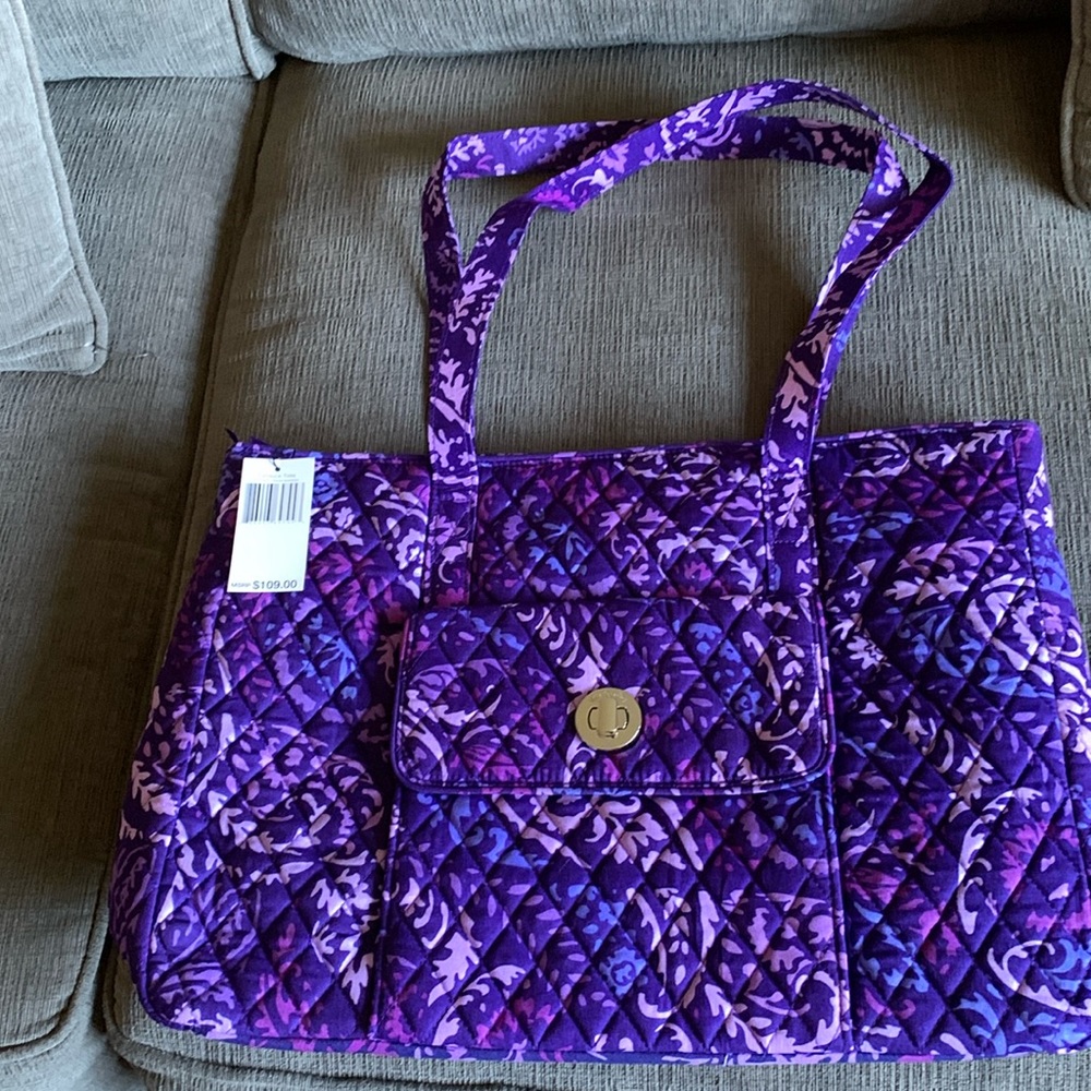 Tote with compartment on front with turnlock closure and zipped top. nwt